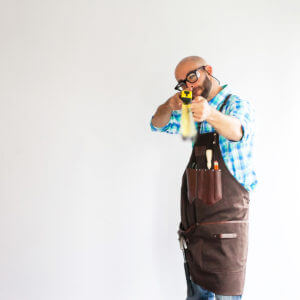 image of austin waldo man holding tape measuring at austin school of furniture and design