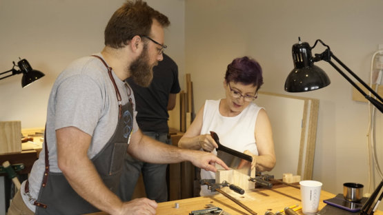 woodworking instructor showing sawing technique woodworking class Austin School of Furniture
