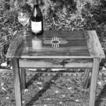wine bottle and glass on custom furniture side table
