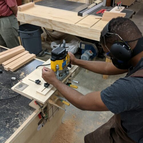 student wearing safety gear making a mortise