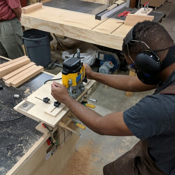 student wearing safety gear making a mortise