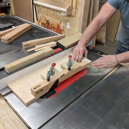 woodworking student tapering a leg on table saw jig