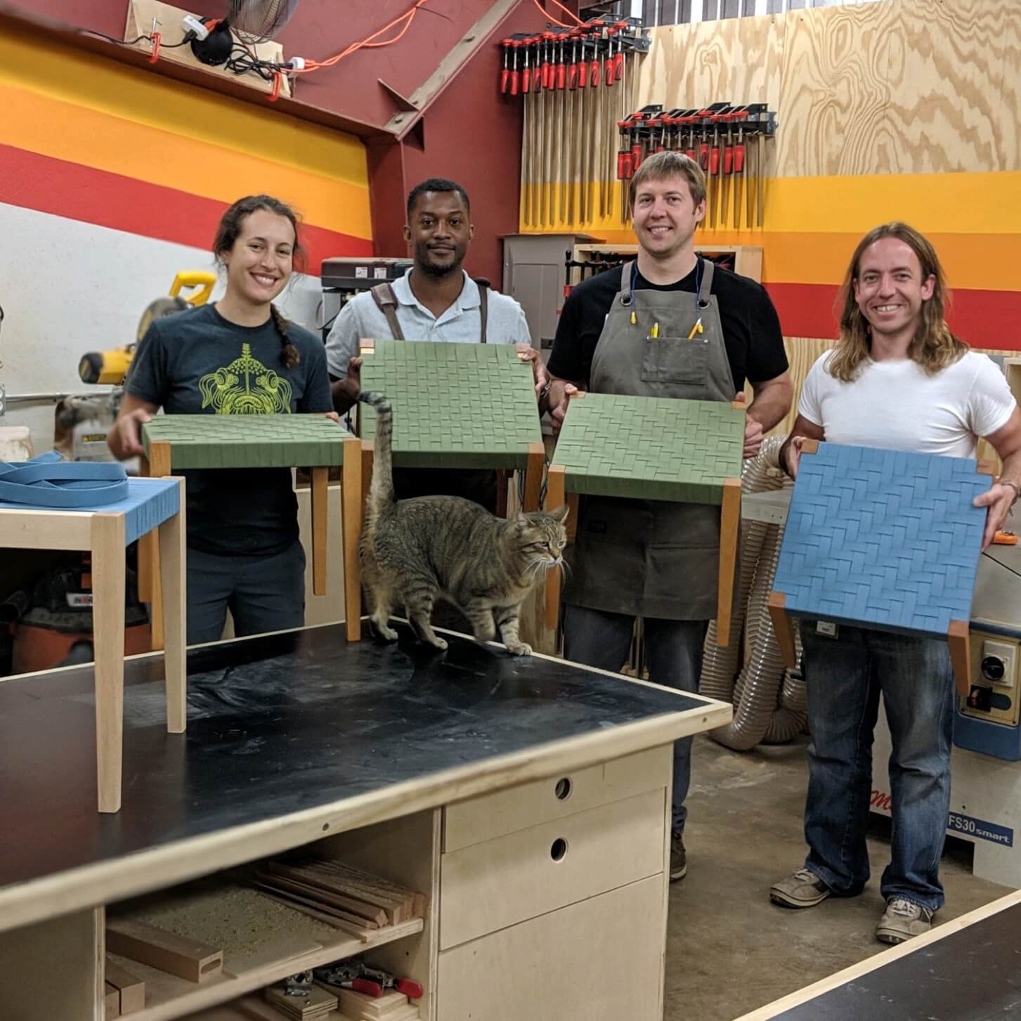 group of male and female woodworkers with shaker tape woven stools
