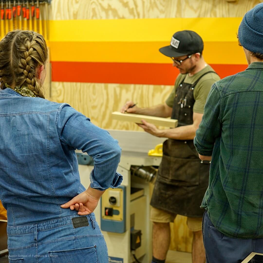 woodworker at austin school of furniture showing students how to mill wood