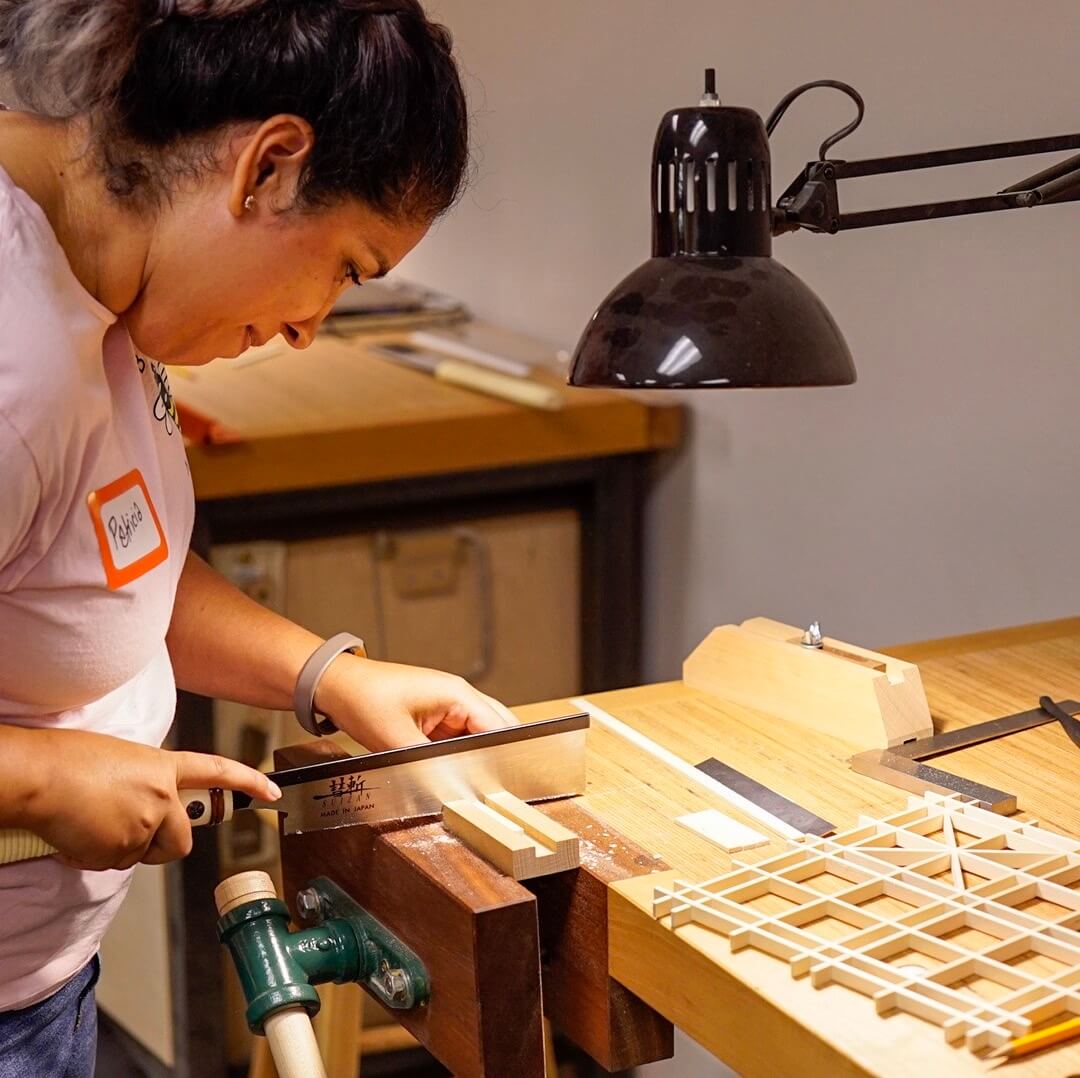 woman woodworker making a kumiko panel