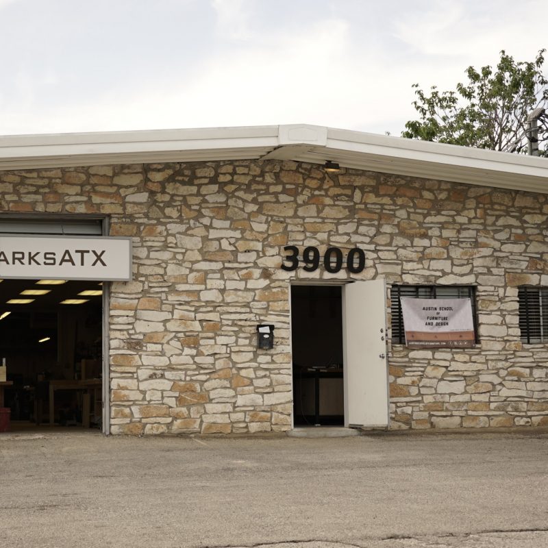 outside front view of limestone lined warehouse woodworking shop